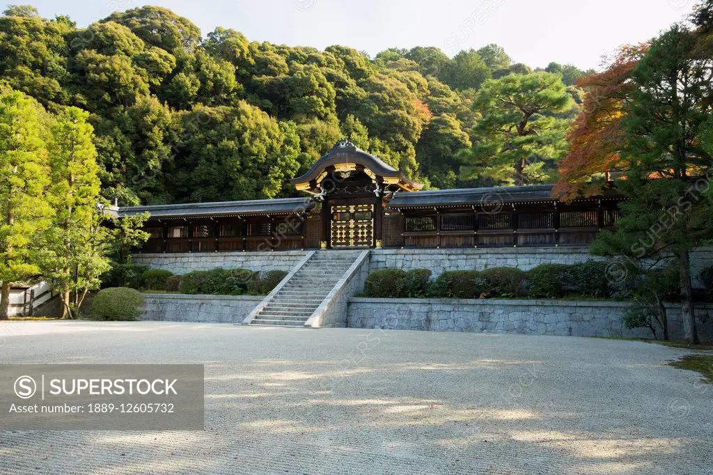 Large Japanese temple wood and stone wall with gate and stone steps; Kyoto, Japan