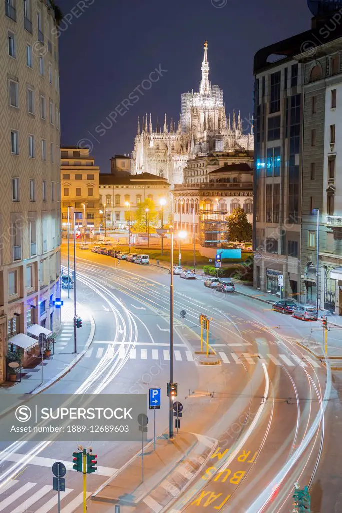 Light trails on the streets with Milan Cathedral illuminated at dusk; Milan, Lombardy, Italy