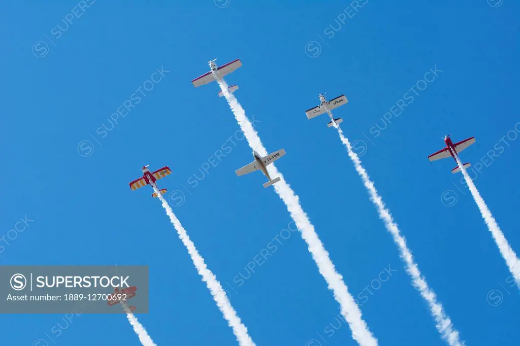 Six aerobatic aircraft flying up in formation with smoke on; Rivadavia, Mendoza, Argentina