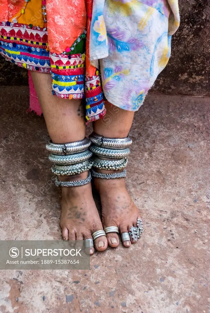 Jewelry on the legs and feet of a Karnataka woman; Goa, India