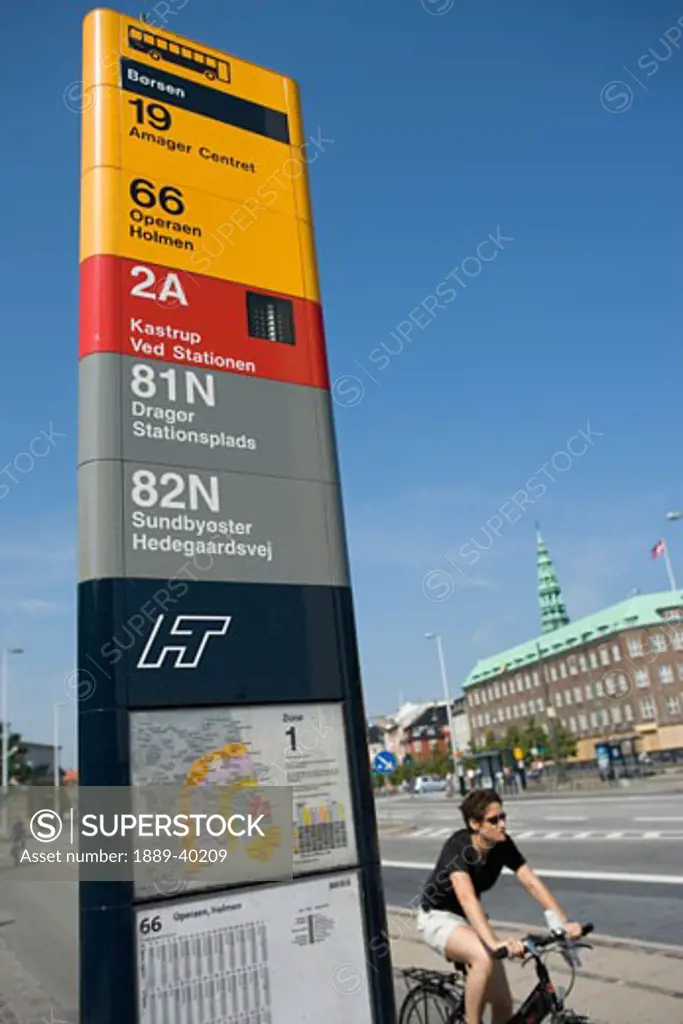 Copenhagen, Denmark; Bus stop with cyclist riding by  