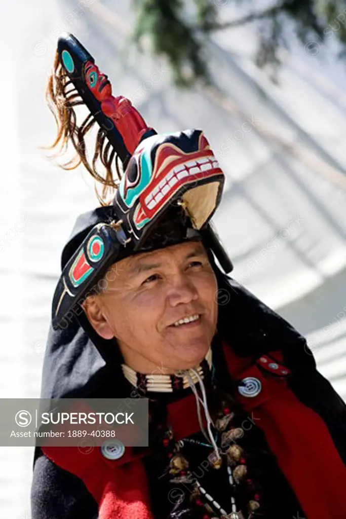 Man wearing native american costume; Vancouver, Canada
