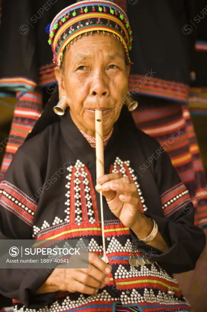 Lahu Shi Balah Tribeswoman playing instrument; Chiang Mai, Thailand