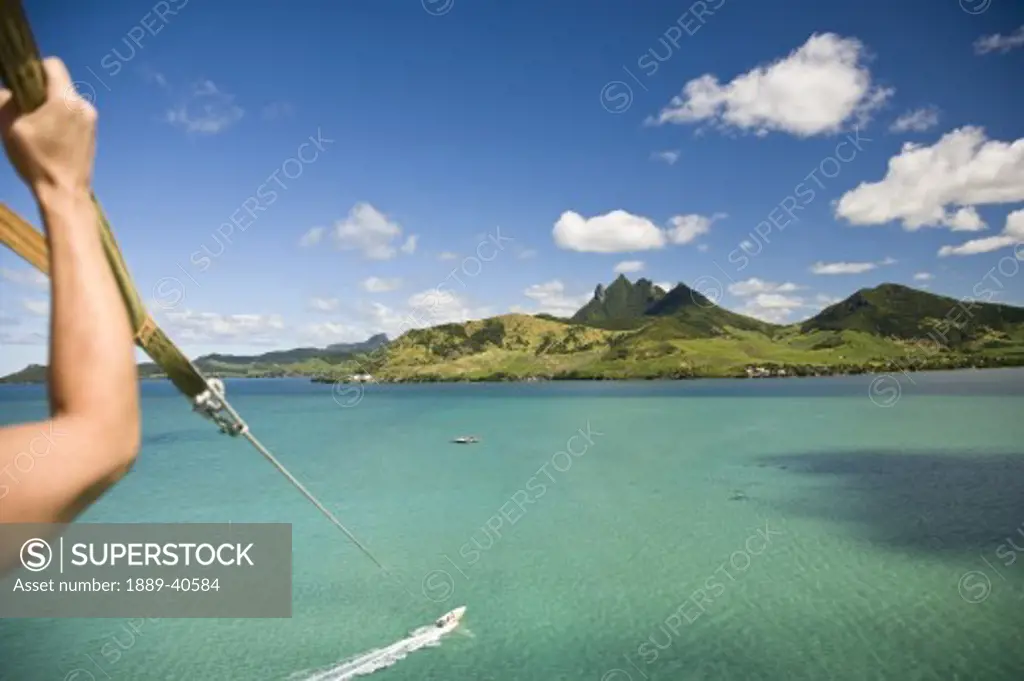 Cropped view of person parasailing with view of Lion Mountain; Mauritius