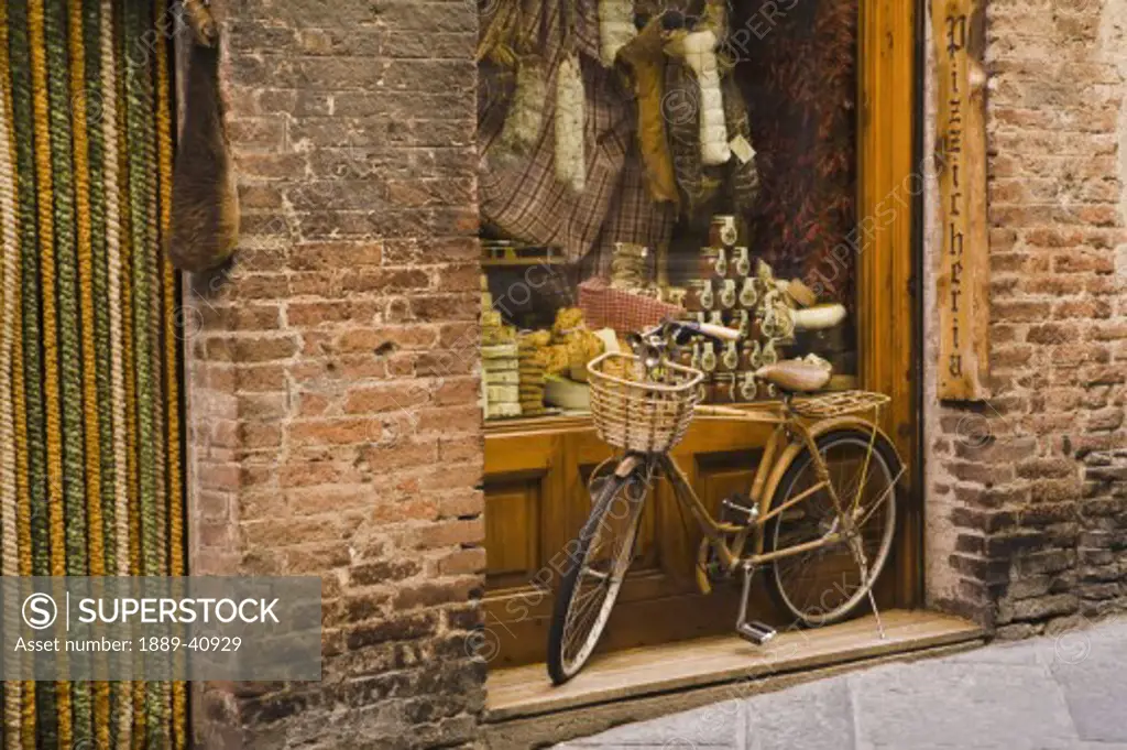 Bicycle outside delicatessen; Siena, Tuscany, Italy