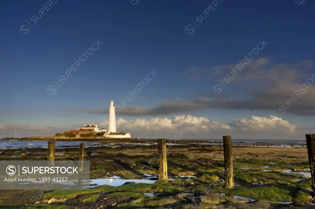 Shore and lighthouse in distance; Whitley Bay, Northumberland, England