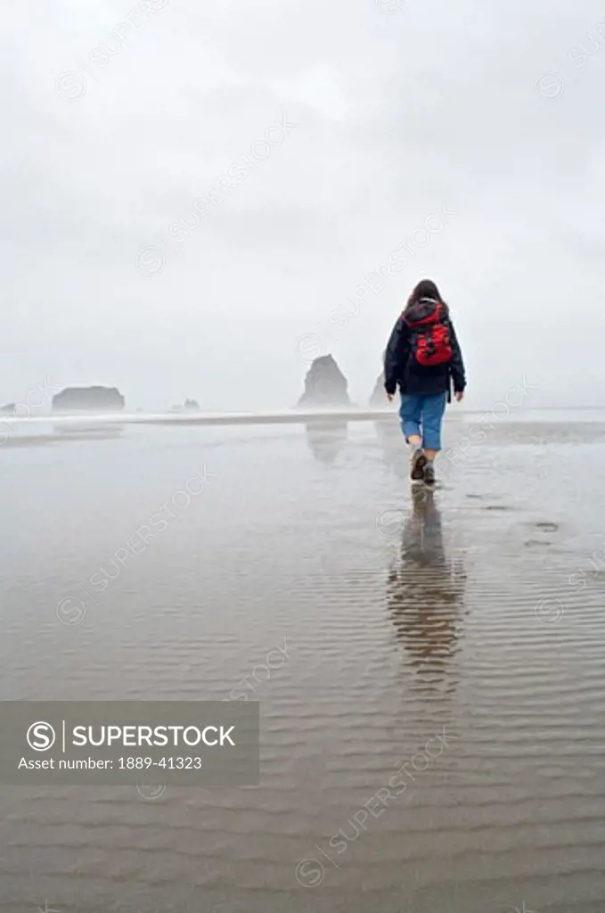 Hiker at Second Beach in Olympic National Park; Washington State, USA