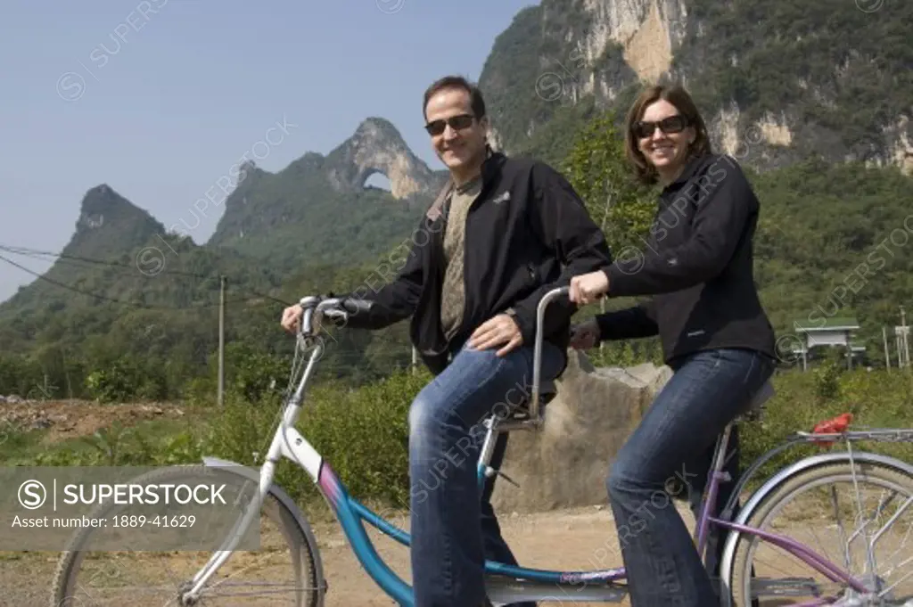 Moon Hill, Yangshuo, China; Couple on tandem bike