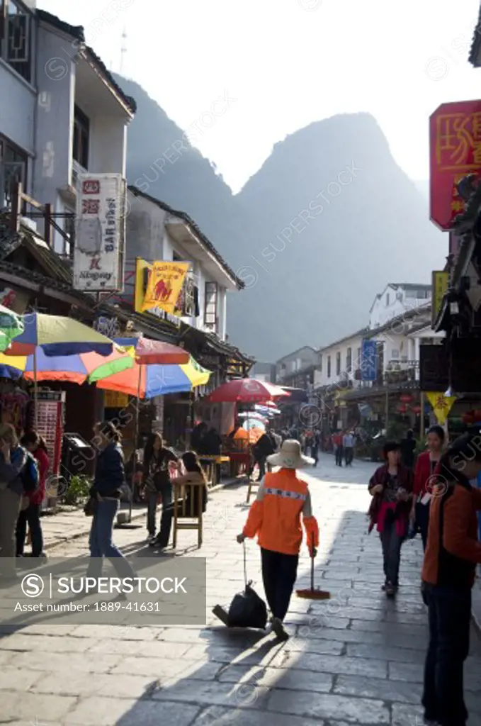 Yangshuo, China; Pedestrians walking through town