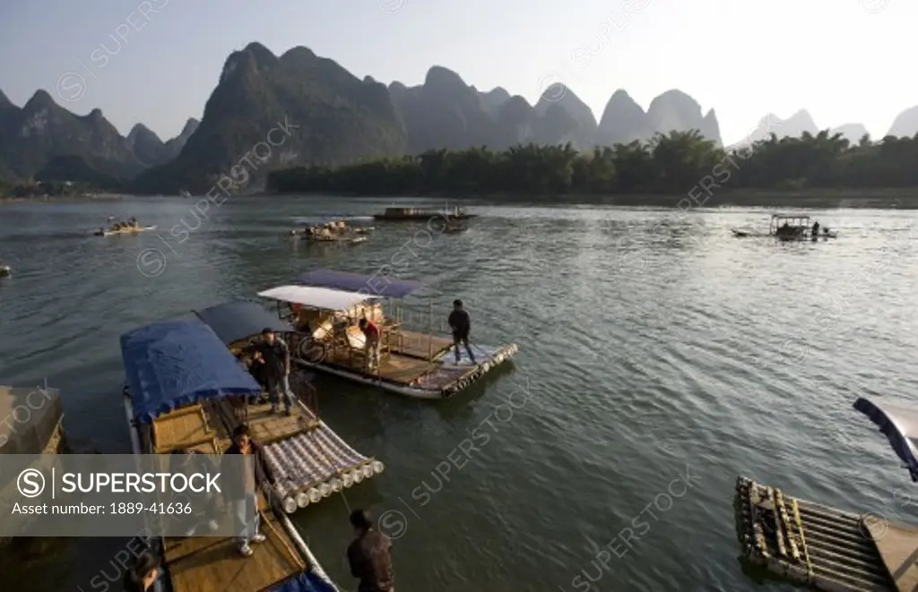 Li River, Yangshuo, China; People in traditional Chinese boats