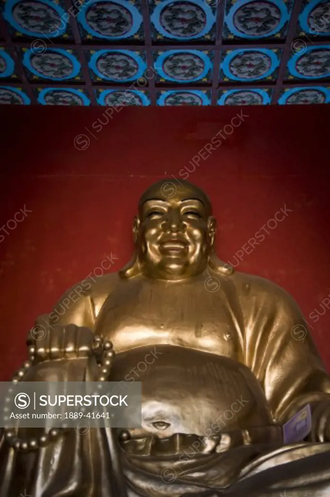 Golden statue of smiling buddha; 