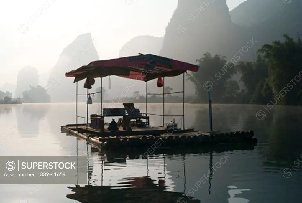 Traditional asian pavilion on lake in mountain area; 