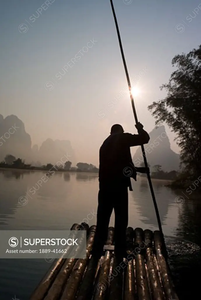 Man on raft in mountain area; 