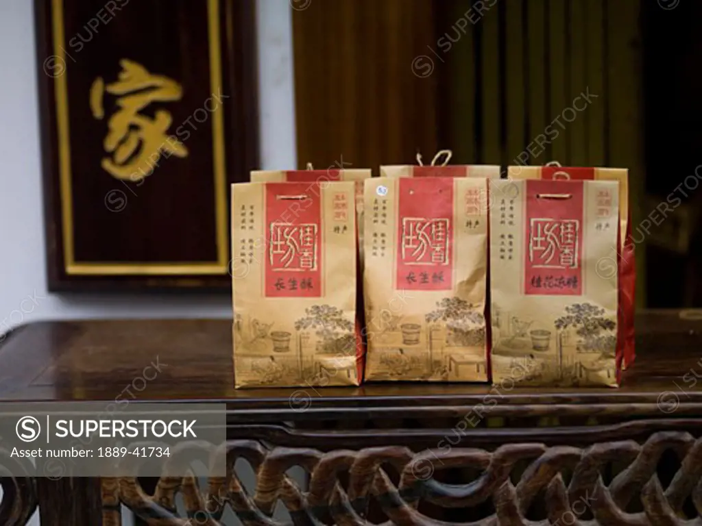Paper bags with asian tea on table; 