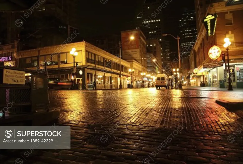 Pike Place Market, Seattle, Washington, USA; City lights reflected in wet street at night