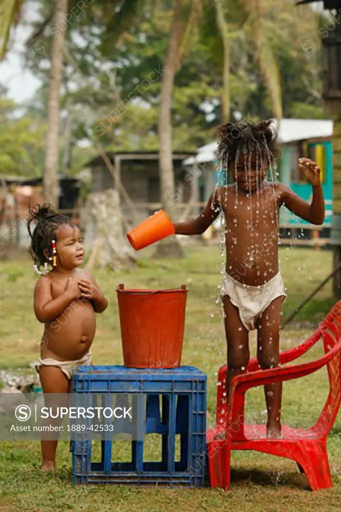 Tasbapauni, Nicaragua; Young girl with red bucket
