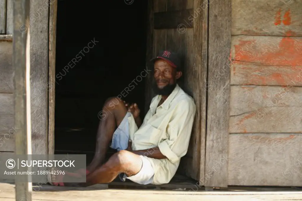 Tasbapauni, Nicaragua; Man relaxing in doorway
