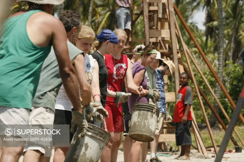 Tasbapauni, Nicaragua; People in a row passing buckets