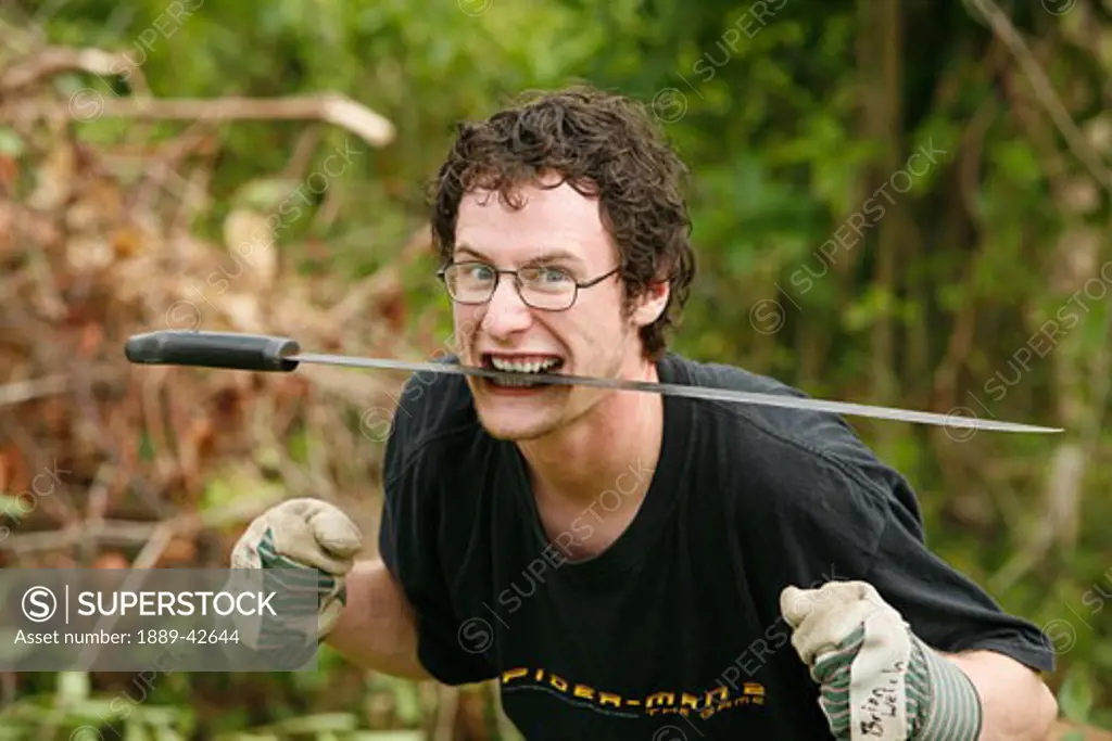 Tasbapauni, Nicaragua; Man holding machete  in mouth