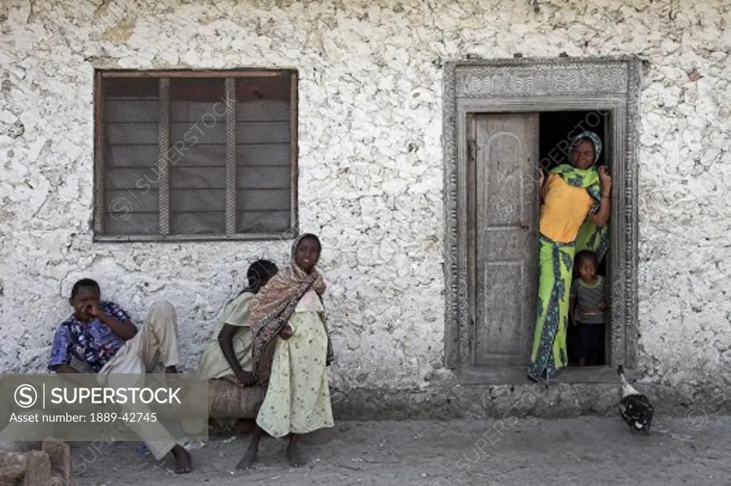 Pwani Mchangani, Zanzibar, Tanzania; Family outside house