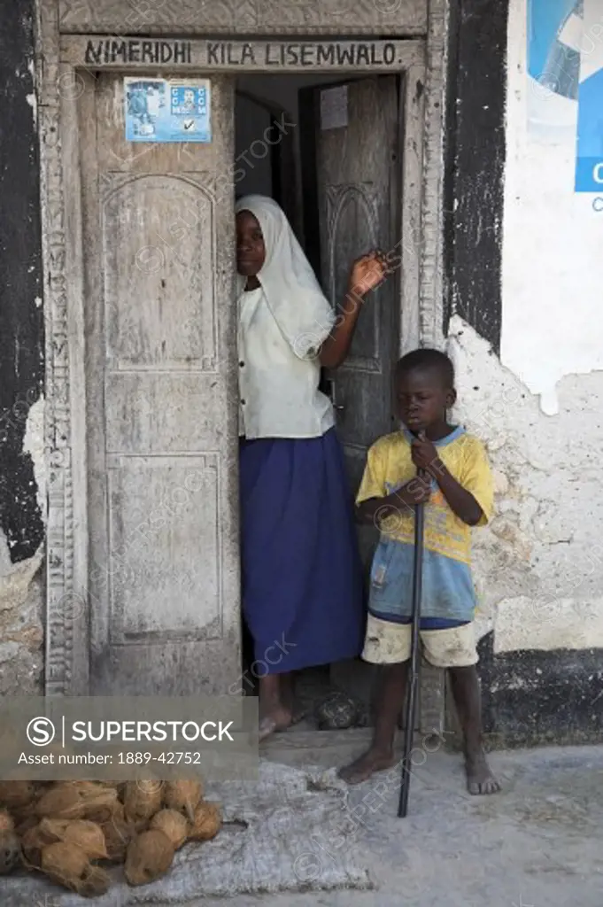 Zanzibar, Tanzania; Brother and sister standing on door