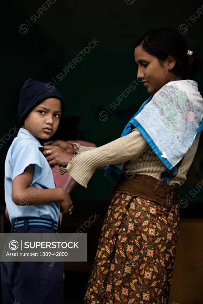 Pokhara, Nepal; Orphan getting dressed