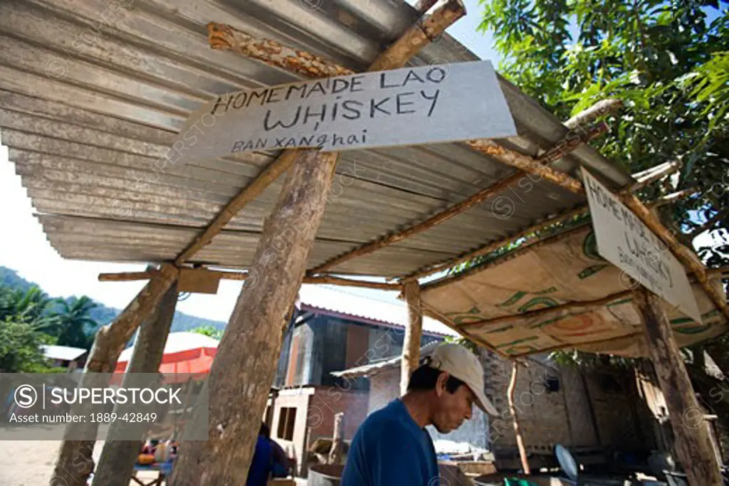 Luang Prabang, Laos; Man selling whiskey