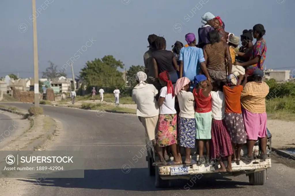 Haiti; People riding on back of truck