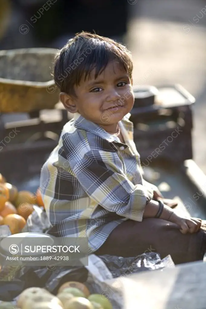 Jodhpur, India; Young boy smiling at camera in market place