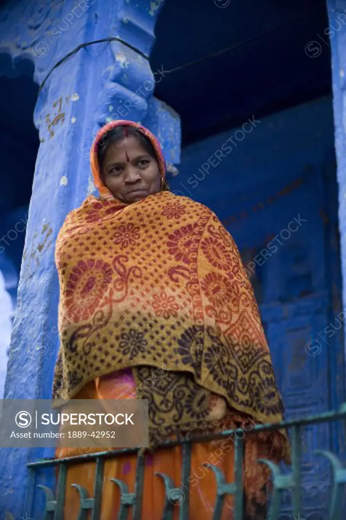 Jodhpur, India; Portrait of woman in traditional clothing standing on balcony