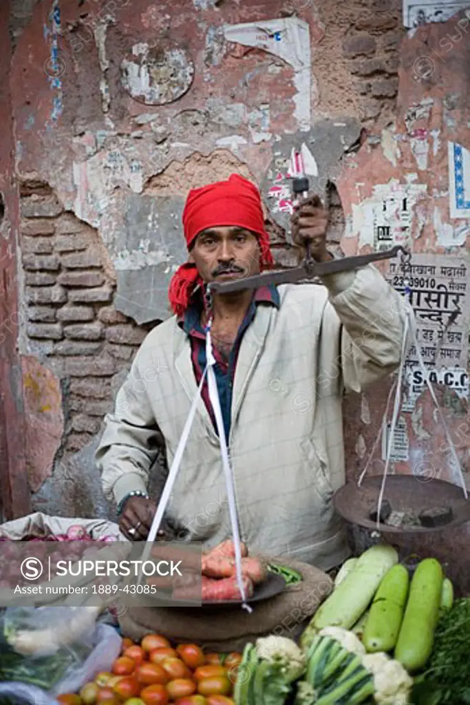 Delhi, India; Man selling vegetables at market