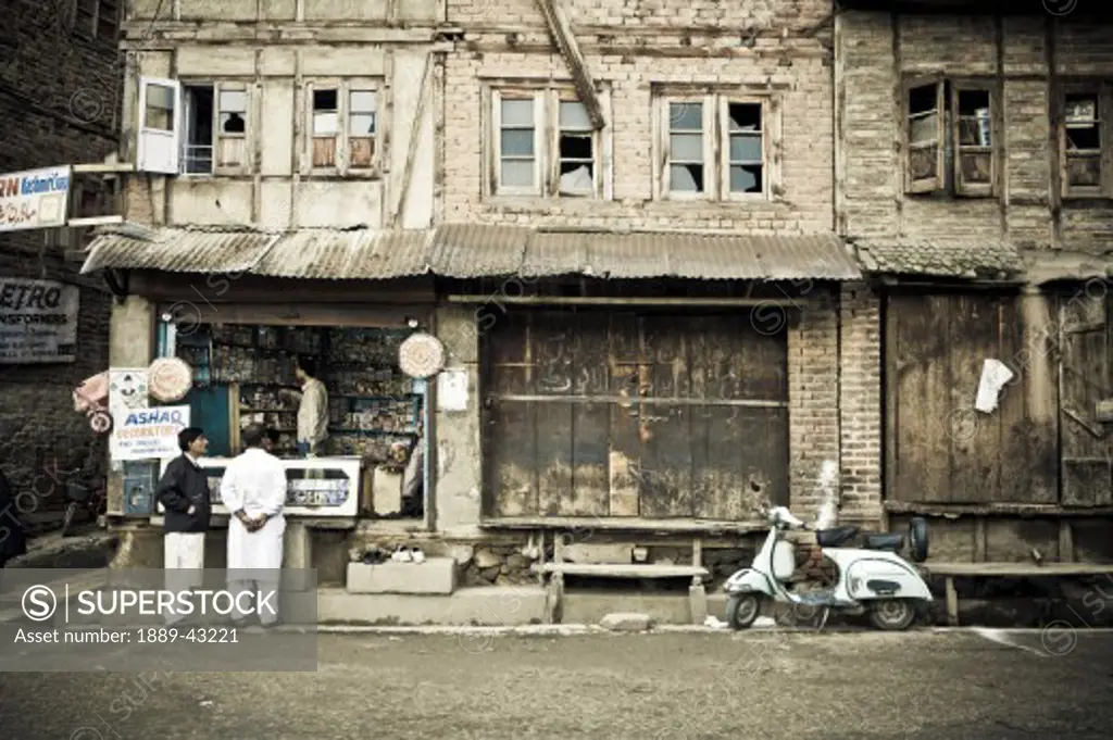 Dal Lake, Srinagar, Kashmir, India; People standing outside shop front