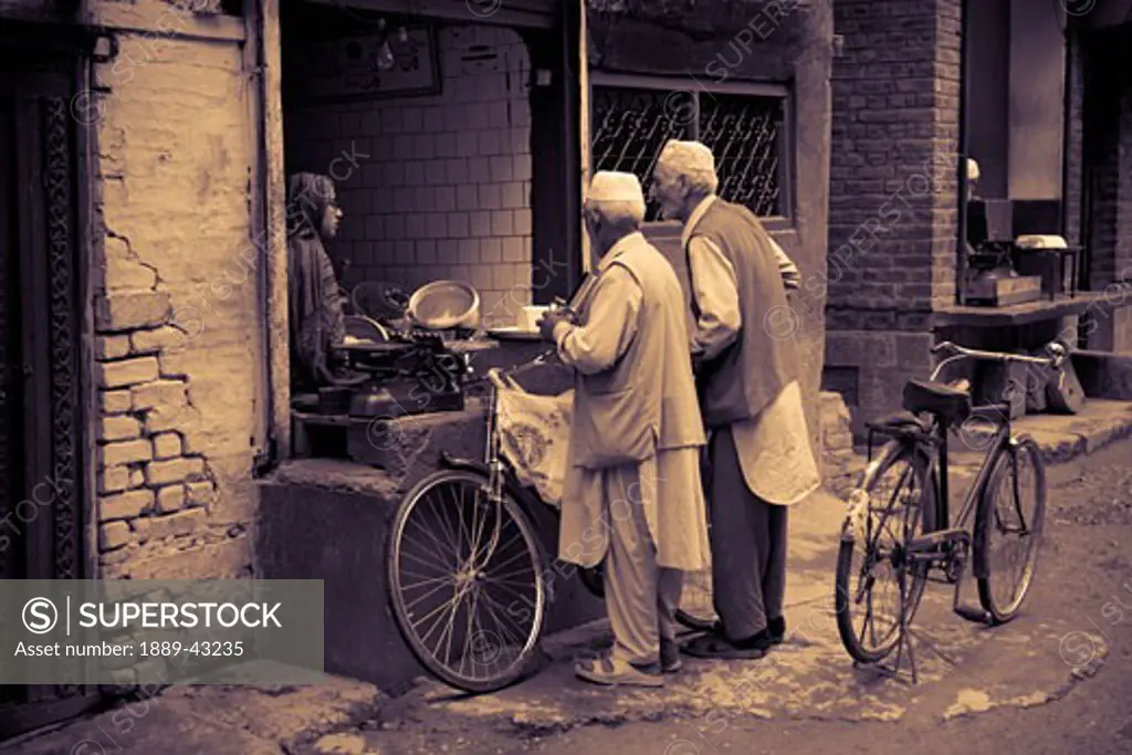 Dal Lake, Srinagar, Kashmir, India; Men in market with bicycles