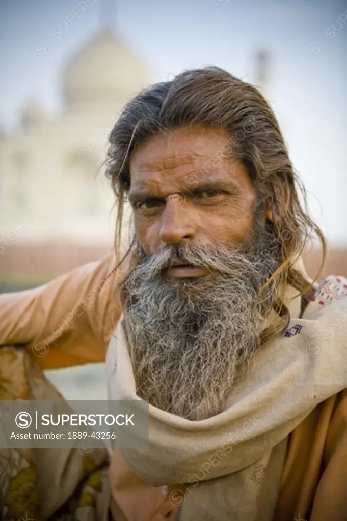 Agra, India; Portrait of man in front of Taj Mahal
