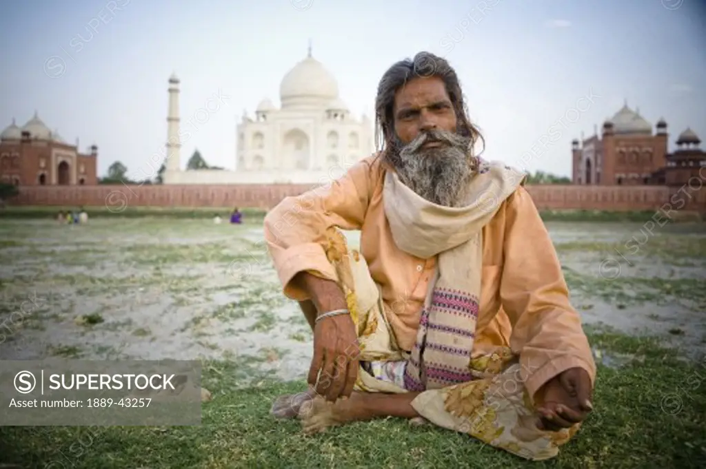 Agra, India; Portrait of man in front of Taj Mahal