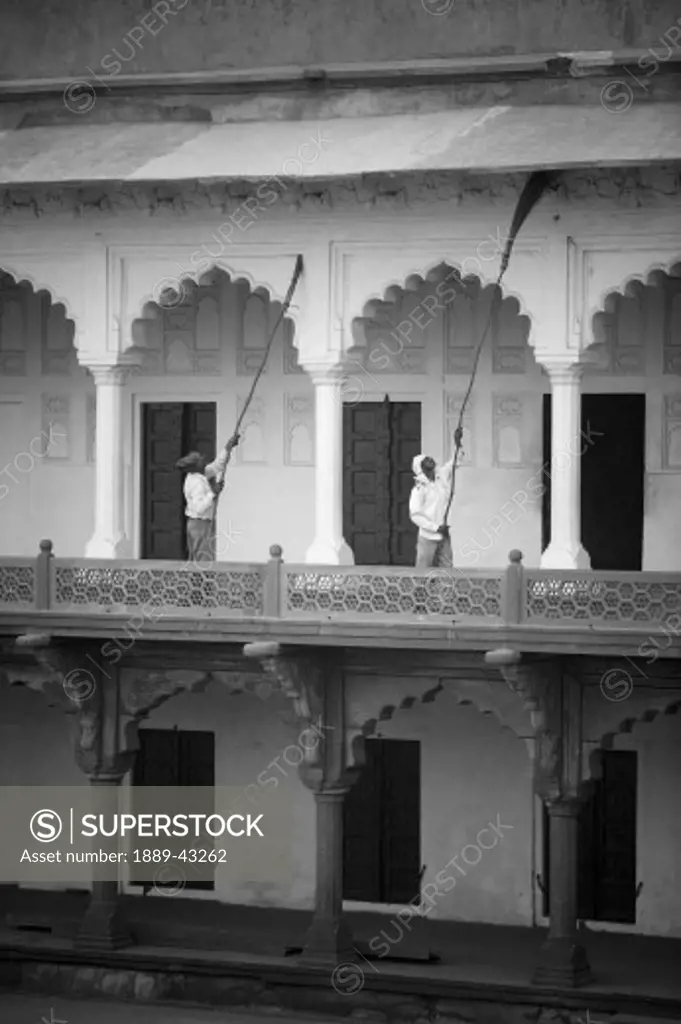 Agra Fort, Agra, India; Men cleaning building exterior