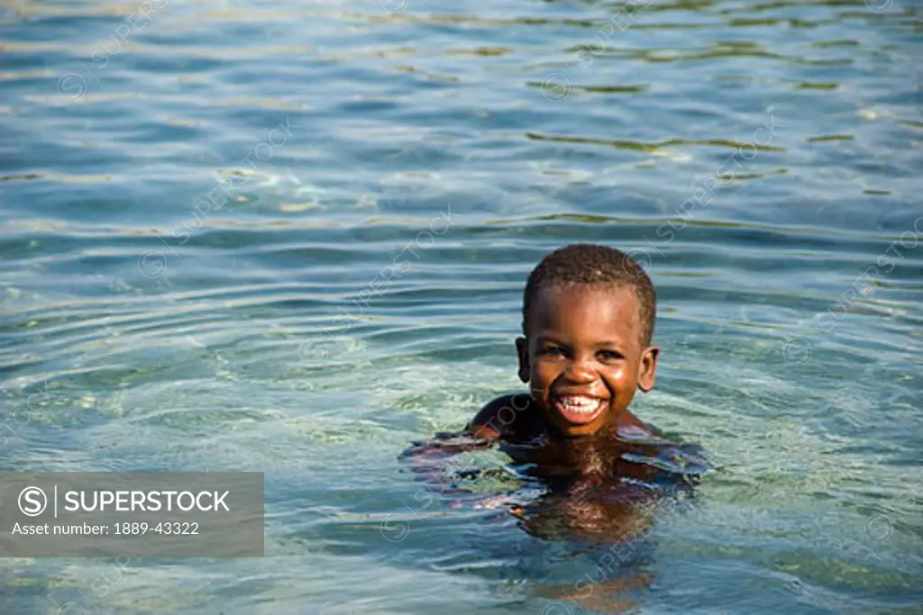 Haiti; Young boy swimming in sea