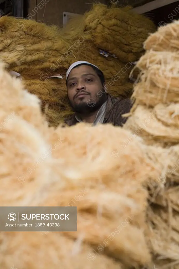 Old Delhi, India; Man sitting amongst wool