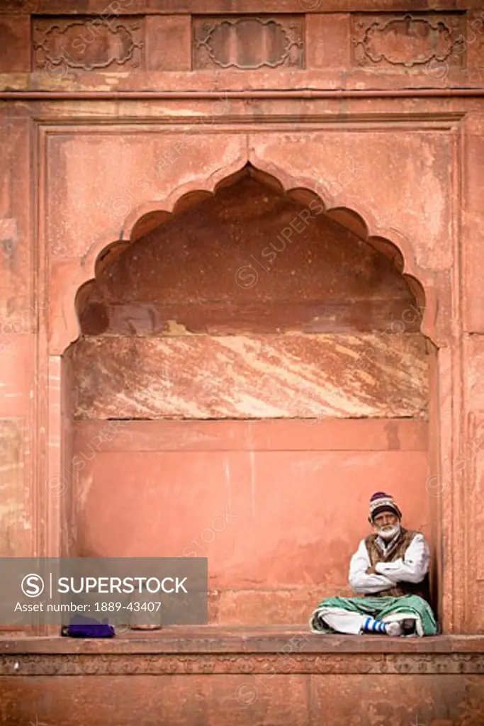 Red Fort (Lal Qil'ah), Delhi, India; Man sitting at the Red Fort