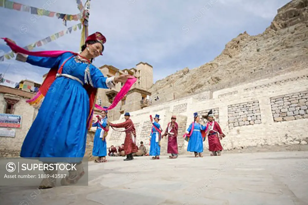 Leh Monastery, Ladakh, Jammu and Kashmir, India; Men and women dancing in square