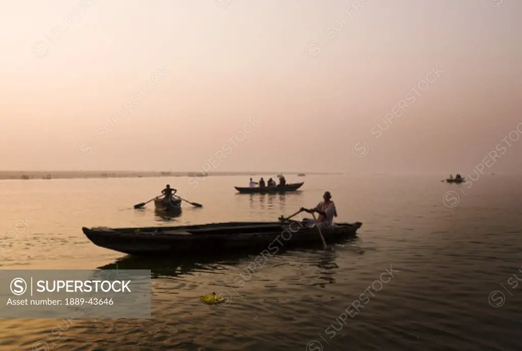 Ganges River,Varanasi,India;People canoeing on the river at sunset