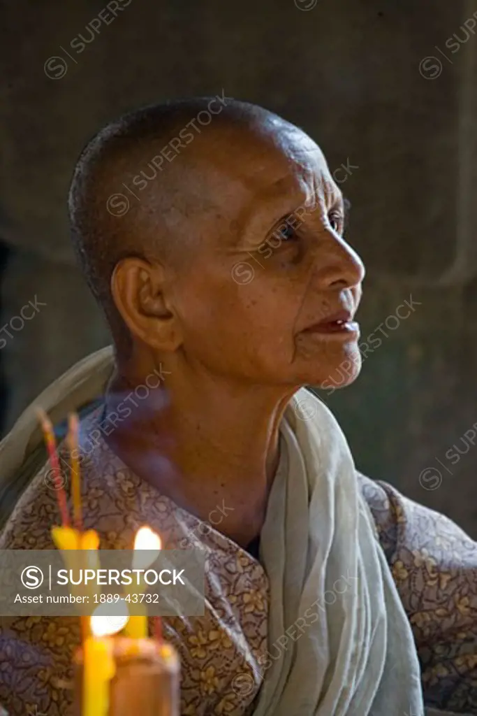Siem Reap,Cambodia;Nun in prayer at Angkor Wat Temple