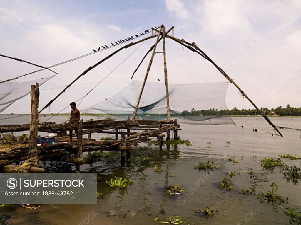 Cochin,India;Chinese fishing nets over run down wharf