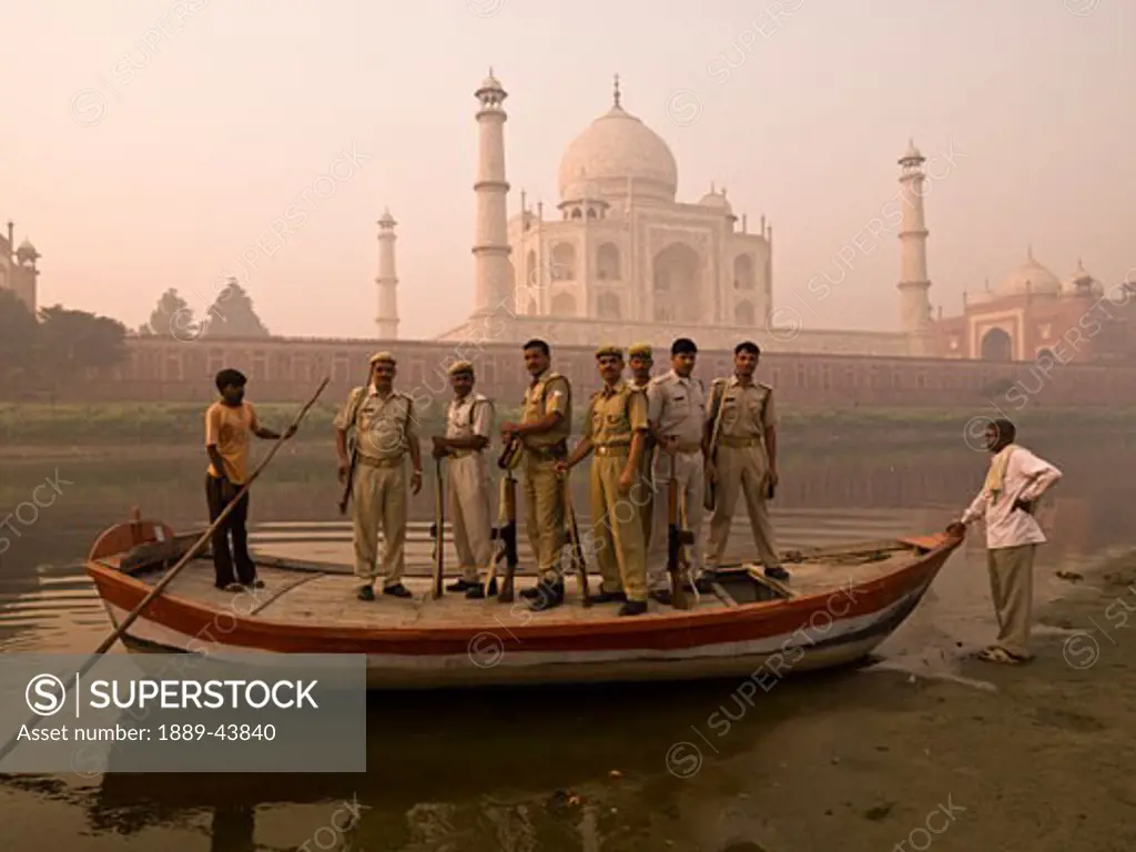 Taj Mahal,Agra,India;Armed soldiers standing on a boat by the Taj Mahal