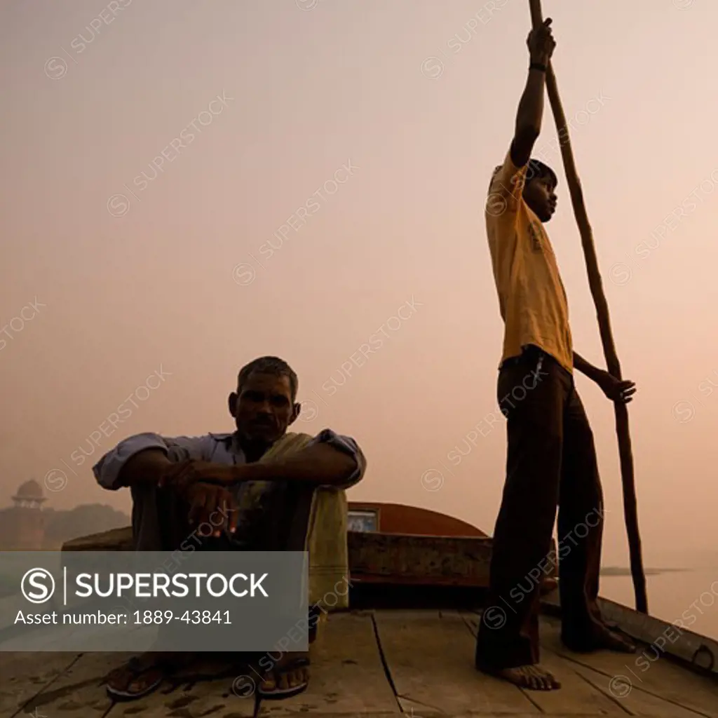 Agra,India;Men on a boat at sunset