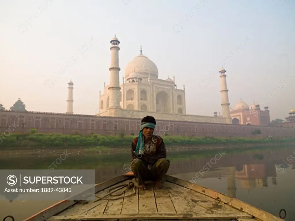 Taj Mahal,Agra,India;Man sitting on a boat by the Taj Mahal