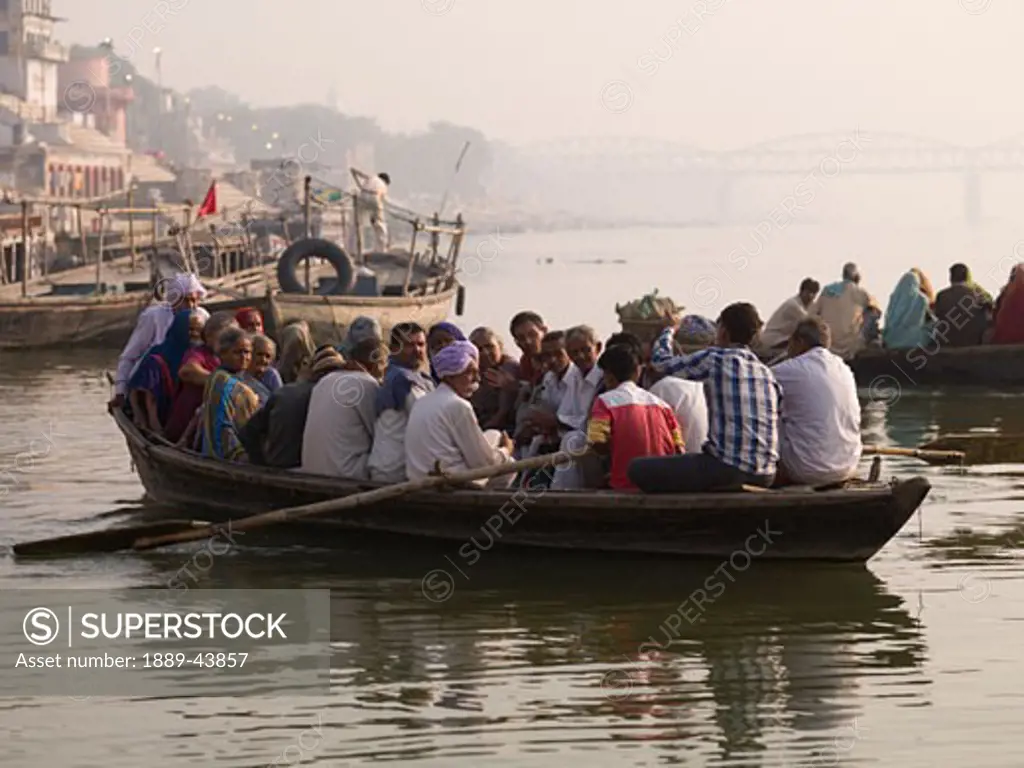 Varanasi,India;People on a boat for transport down the Ganges River