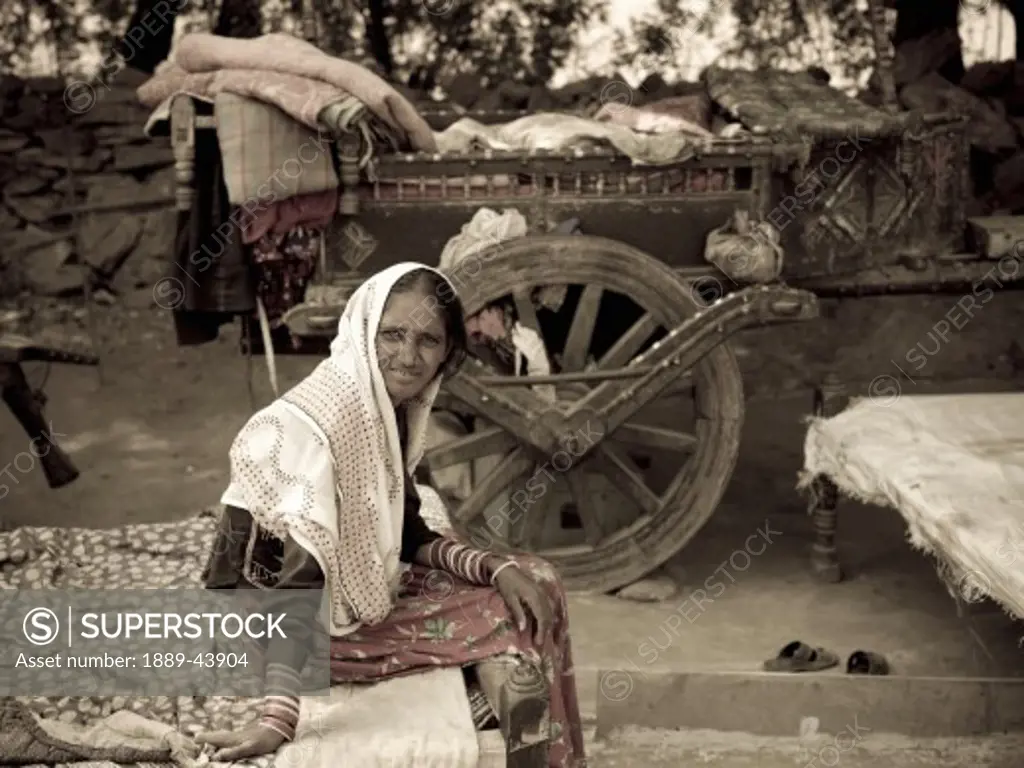 India;Portrait of Indian gypsy woman sitting by her cart