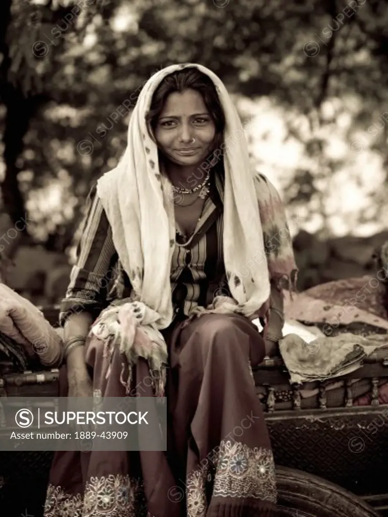 India;Portrait of young Indian gypsy woman,sitting on her cart