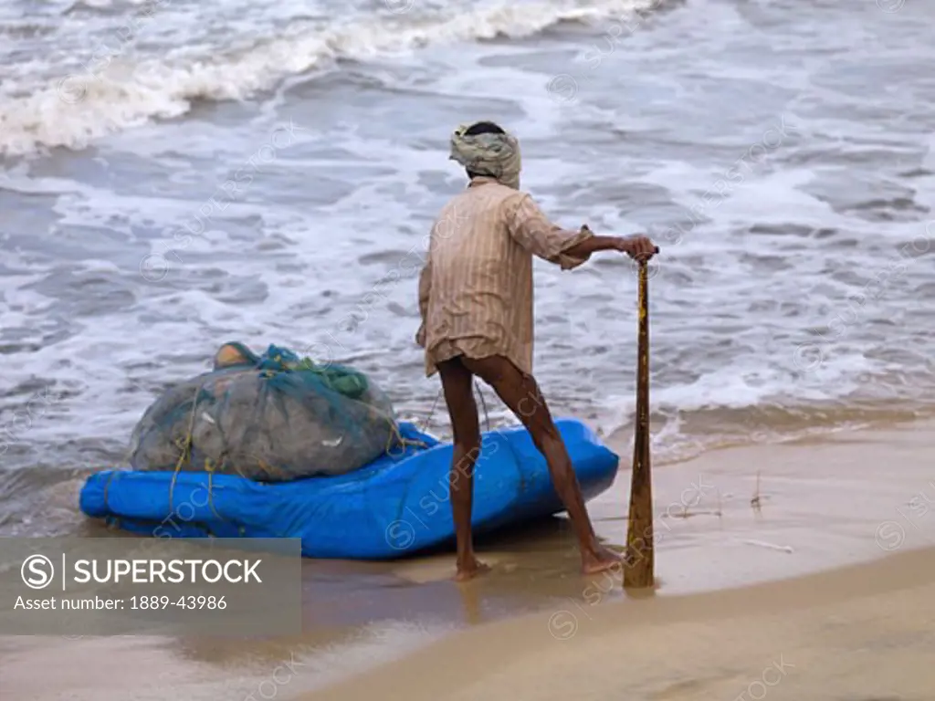 Arabian Sea,Kerala,India;Fisherman hauling his catch ashore